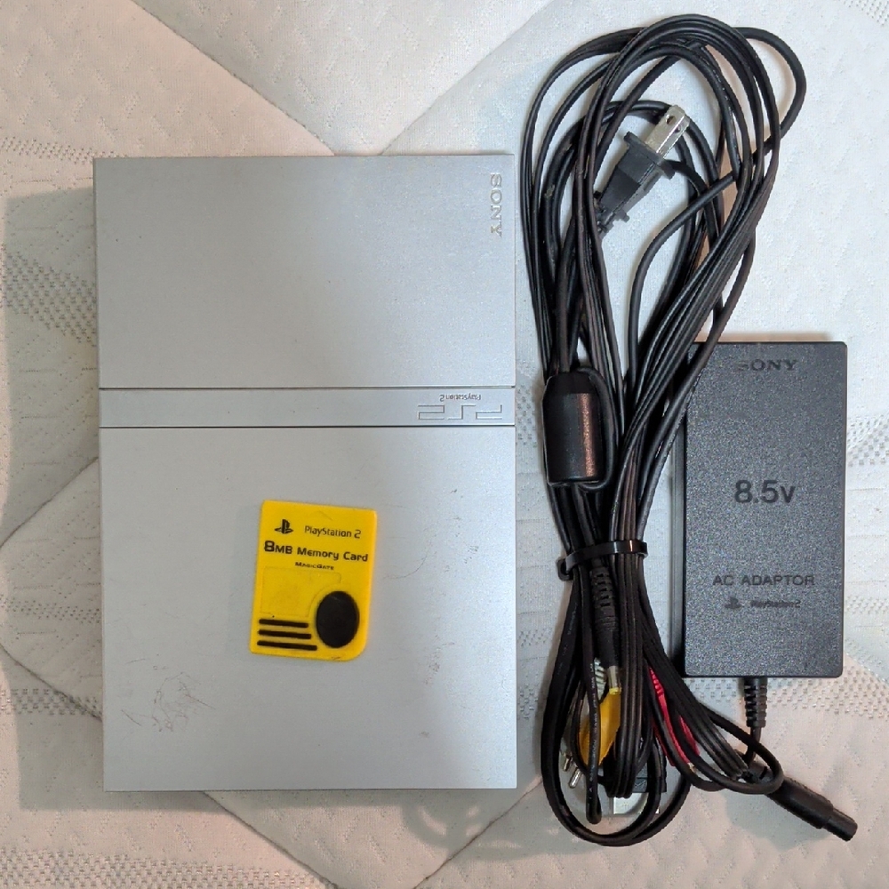 Sony PlayStation 2 Slim Console with Yellow Memory Card and Black Power Cables